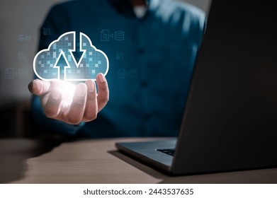 database, cloud, link, networking, server, solution, computing, information, web, system. A person is holding a laptop with a cloud icon on it. Concept of technology and the importance of data storage