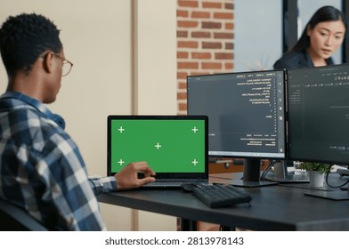 Database Designer Coding with Laptop Mockup uses a laptop chroma key screen in a software development workspace, with blank copy space and isolated mockup background for editable screen replacement.
