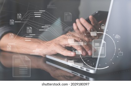 Database directory, E-document, paperless office concept. Business man working on laptop computer with electronic document, folder and files icon on virtual screen, cloud computing