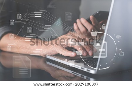 Database directory, E-document, paperless office concept. Business man working on laptop computer with electronic document, folder and files icon on virtual screen, cloud computing