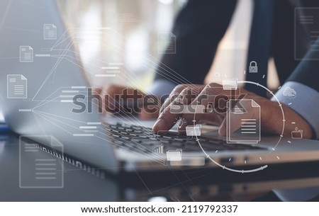 Database directory, E-document, paperless office concept. Business man working on laptop computer with electronic document, folder and files icon on virtual screen, cloud computing