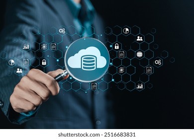 Database management concept, cloud computing data management technology system. Businessman using magnifying glass focus to database management icon on virtual screen. - Powered by Shutterstock