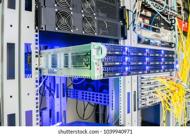 The database server on the skid is placed in the data center rack. Powerful computer equipment close-up. Hosting in a modern server room. The concept of Internet technologies.