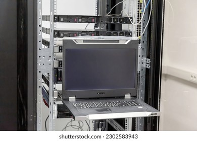 Datacenter server console. Information display in Datacenter server room. Installation of server hardware in the network computer rack and monitor of hardware's work. - Powered by Shutterstock - Get 15% off with code: PIKWIZARD15