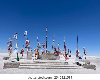 Date 15.October 2024 Flags of multiple countries at the Dakar Sign Salar de Uyuni in Bolivia