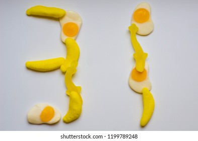 Date 31 Made From Yellow Gummy Candies On A White Background. (bananas, Sharks, Fried Eggs)