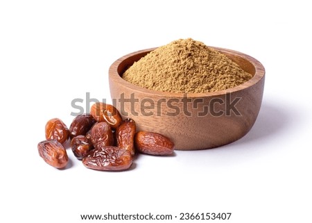 Date fruit powder in wooden bowl with dried dates palm fruits isolated on white background.