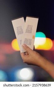 Date night starts here. Shot of an unrecognizable person holding up two tickets.