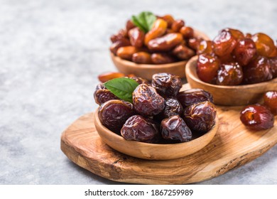 Dates or dattes palm fruit in wooden bowl is snack healthy. - Shutterstock ID 1867259989