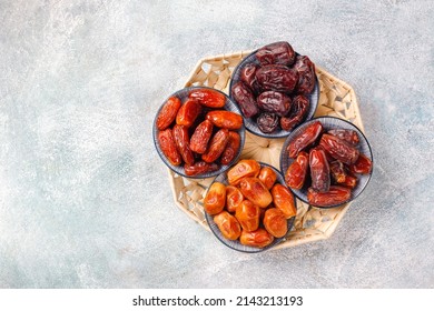 Dates or dattes palm fruit in wooden plate is snack healthy, Set of various dates bowl, Different kind of raw date fruit ready to eat, concrete background, Traditional, delicious and healthy ramadan - Shutterstock ID 2143213193