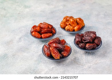 Dates or dattes palm fruit in wooden bowl is snack healthy, Set of various dates in bowl, Different kind of raw date fruit ready to eat, concrete background, Traditional, delicious and healthy ramadan - Shutterstock ID 2143215707