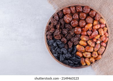 Dates or dattes palm fruit in wooden bowl is snack healthy, Set of various dates in bowl, Different kind of raw date fruit ready to eat, concrete background, Traditional, delicious and healthy ramadan - Shutterstock ID 2149463123