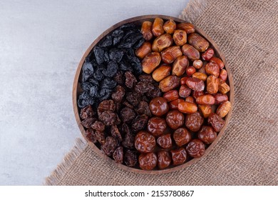 Dates or dattes palm fruit in wooden plate is snack healthy, Set of various dates bowl, Different kind of raw date fruit ready to eat, concrete background, Traditional, delicious and healthy ramadan - Shutterstock ID 2153780867