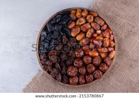 Dates or dattes palm fruit in wooden plate is snack healthy, Set of various dates bowl, Different kind of raw date fruit ready to eat, concrete background, Traditional, delicious and healthy ramadan