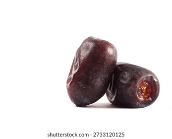 Dates (Phoenix dactylifera) are densely packed against a clean white background.