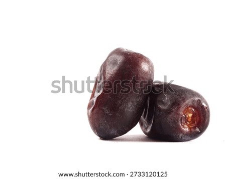 Dates (Phoenix dactylifera) are densely packed against a clean white background.