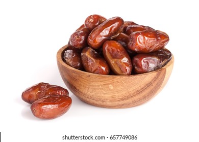 Dates in a wooden bowl isolated on white background