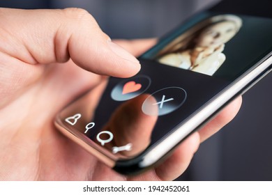 Dating app and online site in mobile phone. Swipe right or left. Beautiful single woman. Man looking for love, romance and relationship on internet with smartphone. Flirting or cheating.
