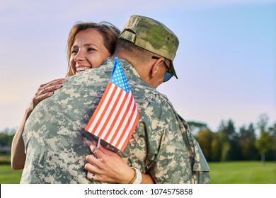 Dating Of Happy Woman And Her Husband Us Army Soldier. Wife With Us Flag Is Hugging Her Military Husband, Close Up.