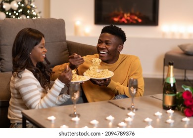 Dating Romance. Loving African American Couple Celebrating Valentine's Day Having Dinner, Eating Pasta And Laughing Enjoying Date At Home. Romantic Relationship, Valentine Celebration Concept