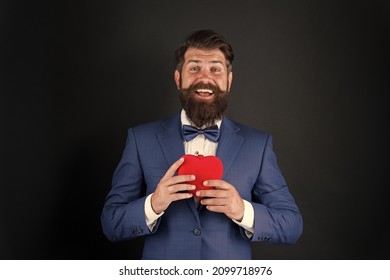 Dating services. Gentleman concept. True gentleman. Valentines day. Well groomed handsome bearded man wear tuxedo. Romance and dating. Gentleman romantic soul. Man hold heart symbol of love
