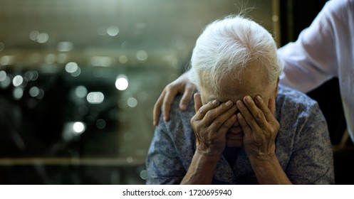 The daughter is comforting an elderly woman who is a mother sadness with Alzheimer's disease and amnesia, Memory loss due to dementia. - Shutterstock ID 1720695940
