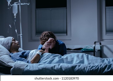 Daughter crying at her dying mother's bed in the hospital. Breast cancer concept - Shutterstock ID 1120183970