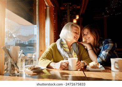 Daughter, happy and senior woman with laughing in cafe for memories or bonding with relax. Restaurant, coffee shop and discussion with people, conversation and smiling family with love in Paris. - Powered by Shutterstock