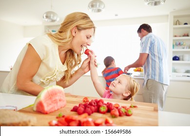 Daughter Helping Mother To Prepare Family Breakfast - Powered by Shutterstock