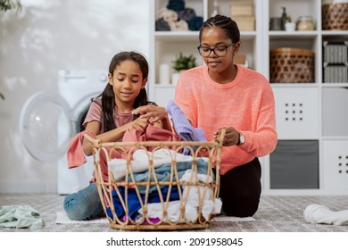 The Daughter Helps Mother With Household Chores, The Women Sort Laundry, Fold Clothes, Prepare Them For Drying, They Spend Time Together In The Bathroom Talking Smiling