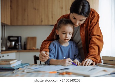 The daughter and her mother do their school homework - Powered by Shutterstock