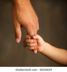 Daughter holds the hand of the father