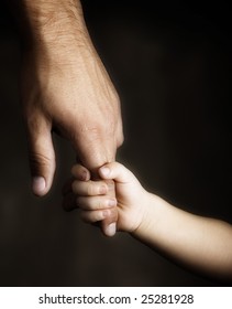 Daughter holds the hand of the father