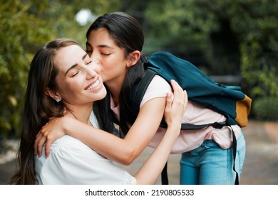 Daughter, Hugging And Giving A Kiss To Her Mom Before Going Into School. Happy Parent Has Strong Relationship And Cute Bond With Her Child. Young Girl Shows Love, Affection And Care For Her Mother.