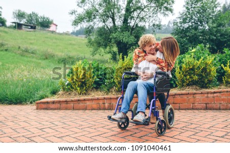 Similar – Granddaughter hugging grandmother in wheelchair