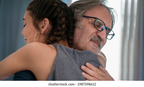 Daughter hugs his own father - Shutterstock ID 1987598612