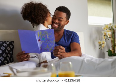 Daughter Kissing Her Dad In Bed On His Birthday Morning