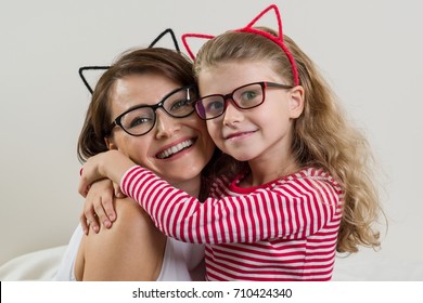 The Daughter Lovingly Embraces Her Mother. Parent And Child In Glasses.