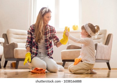 Daughter and mother cleaning home together and having fun. - Shutterstock ID 1038166888
