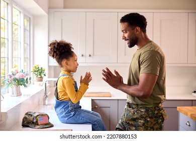 Daughter Playing Game With American Army Father In Uniform On Home Leave In Kitchen - Powered by Shutterstock