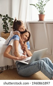 Daughter Plays With Mom And Cat While Mom Works On Computer