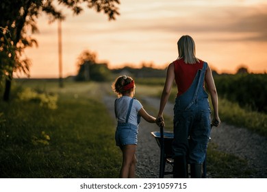 The daughter runs towards her mother in the countryside - Powered by Shutterstock