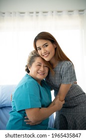 Daughter Of A Senior Patient Taking Care And Encouraging The Mother After Receiving Treatment From The Doctor.