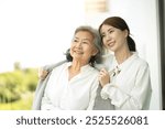 Daughter taking care of her mother by cover with blanket