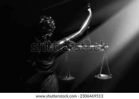 Daughter of Zeus and Themis virgin goddess of innocence and purity Astraea (Astrea, Astria) with mechanical weighing scale of truth and justice. Silhouette of statue. Black and white image.
