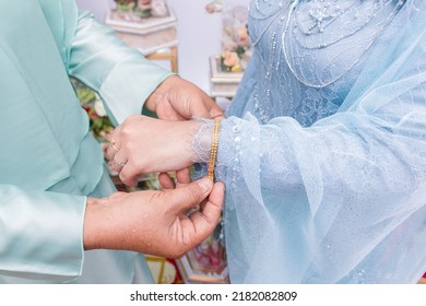daughter-in-law putting bracelets on the bride, on her wedding day