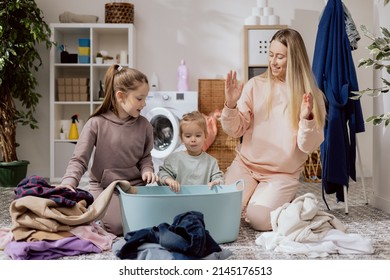 The Daughters Help Their Mother With Household Chores, The Women Sort Laundry, Fold Clothes, Prepare Them For Drying, Spend Time Together In The Bathroom, Talking, Smiling.