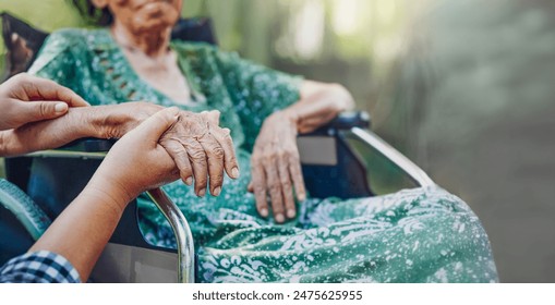 A Daughter's Love. Elderly asian woman on wheelchair at home with daughter take care. - Powered by Shutterstock