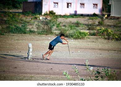 Davangere, Karnataka, India - Feb 28, 2021: A Young Indian Boy Is Batting During A Gully Cricket Game.