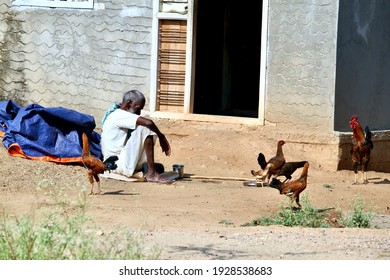 Davangere, Karnataka, India - March 3, 2021: An Old South Indian Depressed Poor Old Farmer Is Sitting In Front Of His House In A Very Sad Manner Or Mood.